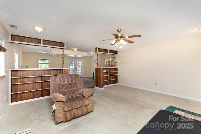 sitting room featuring carpet flooring, french doors, a ceiling fan, baseboards, and visible vents