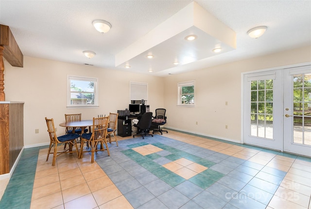office space featuring french doors, baseboards, light tile patterned floors, and a healthy amount of sunlight