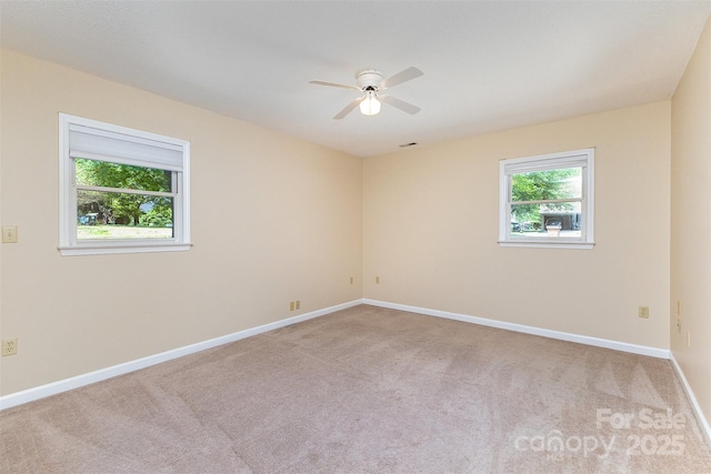 carpeted empty room featuring a ceiling fan, baseboards, and visible vents