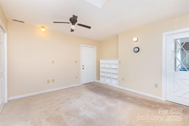 empty room featuring baseboards, ceiling fan, carpet, and visible vents