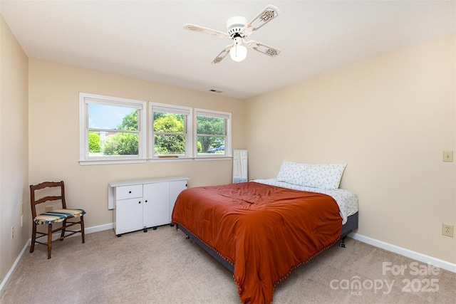 bedroom featuring a ceiling fan, baseboards, light colored carpet, and visible vents