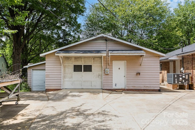 exterior space with cooling unit and a detached garage
