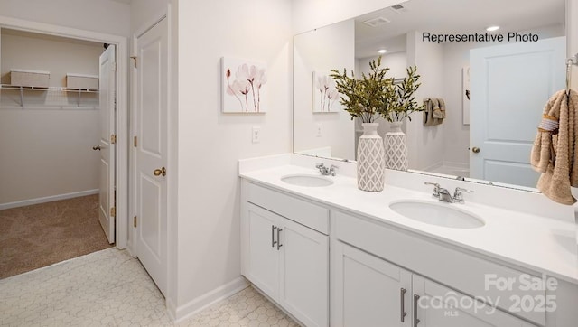 137 Meadow View Dr, Statesville, NC 28677 - full bathroom featuring double vanity, baseboards, and a spacious closet
