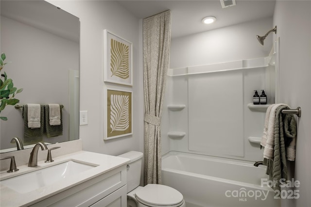 bathroom featuring toilet, shower / tub combo, and vanity