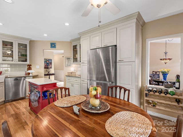 112 Deerlake Dr, Asheville, NC 28803 - kitchen with stainless steel appliances, light wood-type flooring, backsplash, glass insert cabinets, and recessed lighting