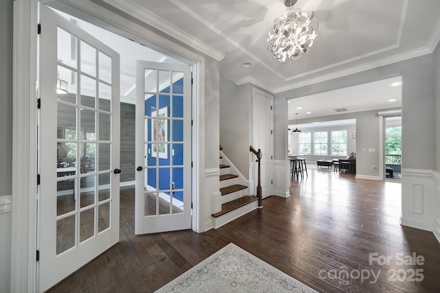 1001 Emory Ln, Fort Mill, SC 29708 - entryway featuring a chandelier, wood finished floors, crown molding, stairs, and wainscoting