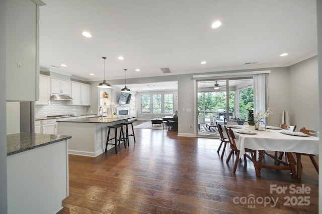 1001 Emory Ln, Fort Mill, SC 29708 - dining space featuring ornamental molding, plenty of natural light, ceiling fan, dark wood-style floors, and recessed lighting