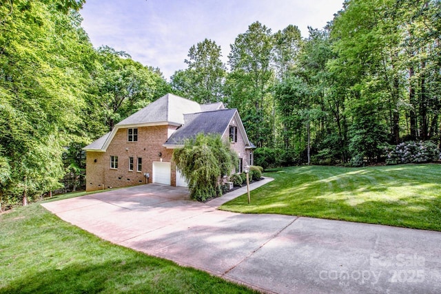 112 Eagle Chase Ln, Troutman, NC 28166 - view of home's exterior featuring brick siding, driveway, a yard, a garage, and roof with shingles