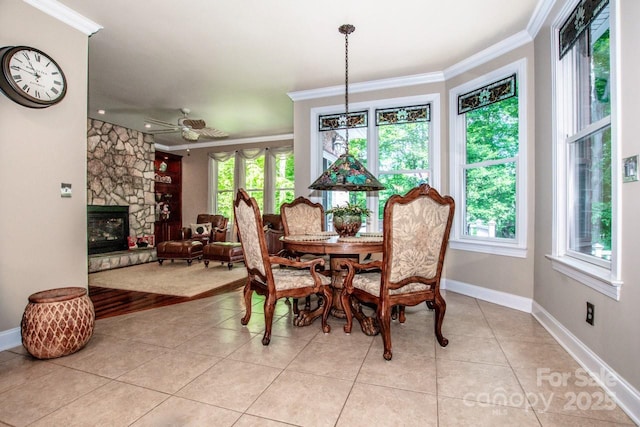 112 Eagle Chase Ln, Troutman, NC 28166 - dining space with ornamental molding, light tile patterned floors, baseboards, and a fireplace