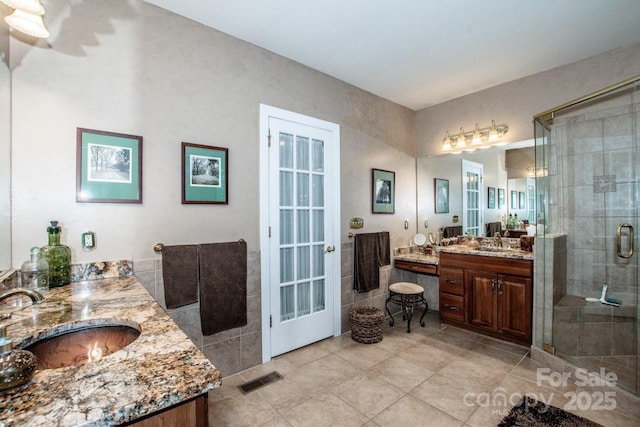 112 Eagle Chase Ln, Troutman, NC 28166 - full bath featuring a shower stall, two vanities, tile patterned flooring, and french doors