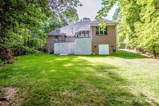 112 Eagle Chase Ln, Troutman, NC 28166 - rear view of house with brick siding, a yard, and a deck