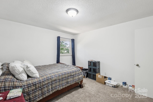 bedroom featuring a textured ceiling and carpet