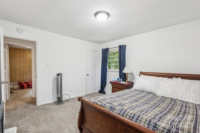 carpeted bedroom with baseboards, a textured ceiling, and a closet