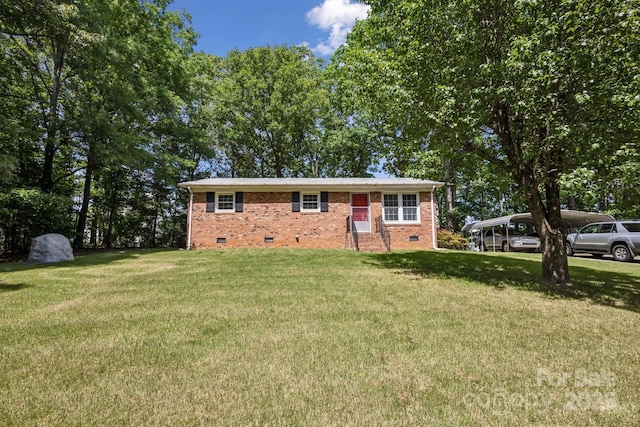 ranch-style house featuring brick siding, a front lawn, a detached carport, and crawl space