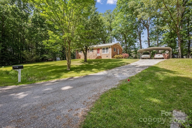view of front of property featuring brick siding, a detached carport, driveway, and a front yard