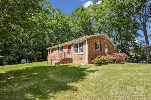 ranch-style house with a front yard, crawl space, and brick siding