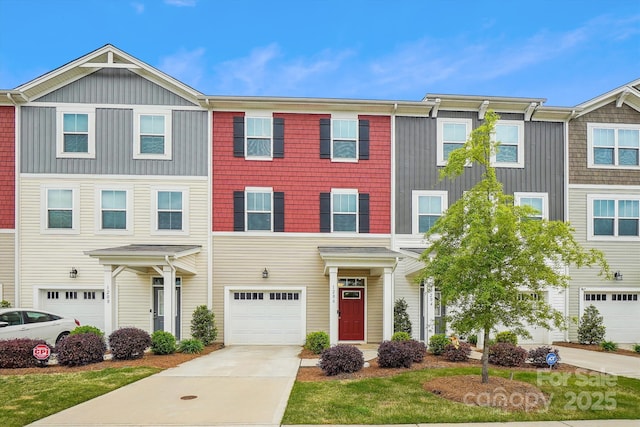 townhome / multi-family property featuring driveway and a garage