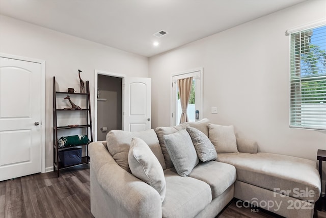 living area with recessed lighting, visible vents, and dark wood-style floors