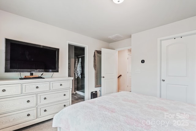 bedroom featuring connected bathroom and visible vents