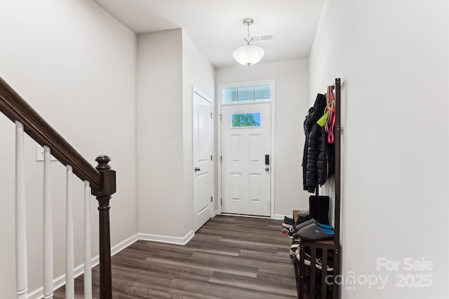 foyer featuring stairs, dark wood-style flooring, baseboards, and visible vents