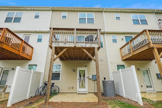 back of property featuring a patio area and fence