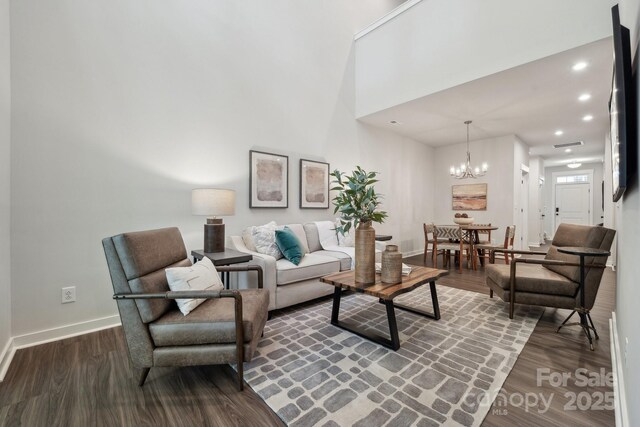 9305 Munsing Dr Unit 142, Charlotte, NC 28269 - living room with an inviting chandelier, recessed lighting, dark wood-style flooring, and baseboards