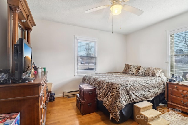 1177 Craigbrow Cir, Chester, SC 29706 - bedroom featuring ceiling fan, a textured ceiling, baseboards, a baseboard radiator, and light wood-style floors