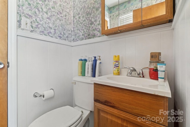 1177 Craigbrow Cir, Chester, SC 29706 - half bathroom featuring vanity, a wainscoted wall, toilet, a decorative wall, and wallpapered walls