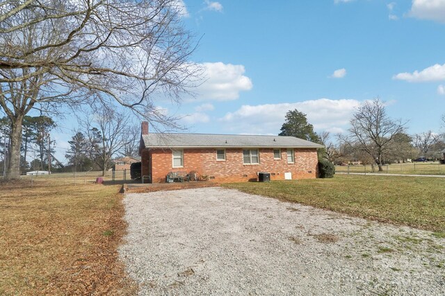 1177 Craigbrow Cir, Chester, SC 29706 - view of front of property featuring a front lawn, fence, a chimney, brick siding, and central air condition unit