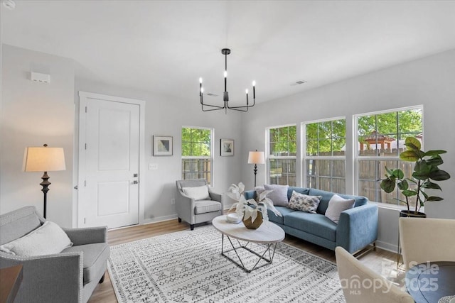1914 White St Unit A & B, Gastonia, NC 28052 - living room featuring an inviting chandelier, visible vents, light wood-style flooring, and baseboards