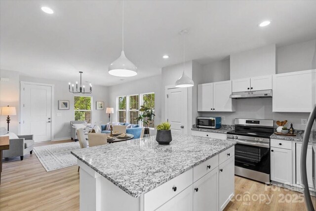 1914 White St Unit A & B, Gastonia, NC 28052 - kitchen with appliances with stainless steel finishes, a center island, under cabinet range hood, white cabinetry, and light wood-type flooring