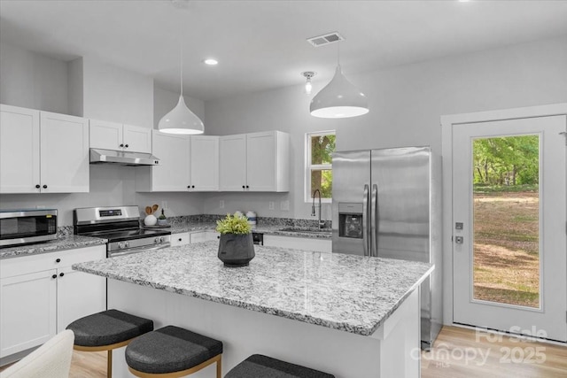 1914 White St Unit A & B, Gastonia, NC 28052 - kitchen with a breakfast bar area, a sink, stainless steel appliances, white cabinetry, and under cabinet range hood