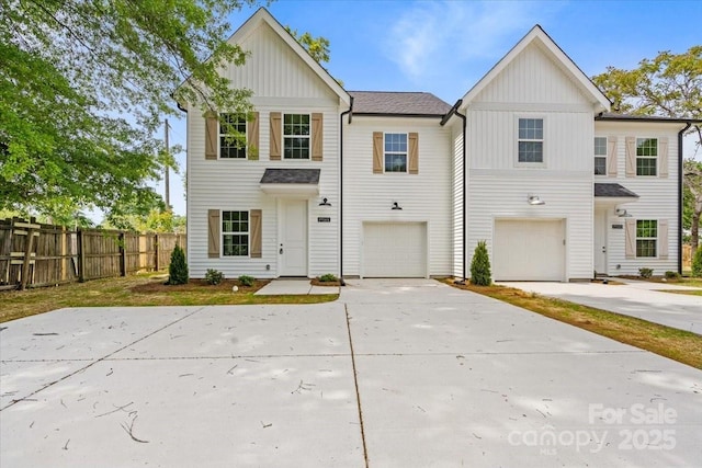 1914 White St Unit A & B, Gastonia, NC 28052 - view of front of house featuring concrete driveway, board and batten siding, fence, and a garage