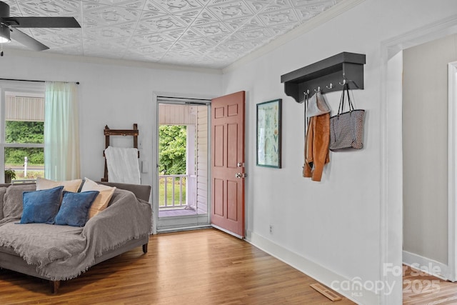 1001 Old Charlotte Rd, Concord, NC 28027 - entryway featuring an ornate ceiling, ceiling fan, crown molding, wood finished floors, and baseboards