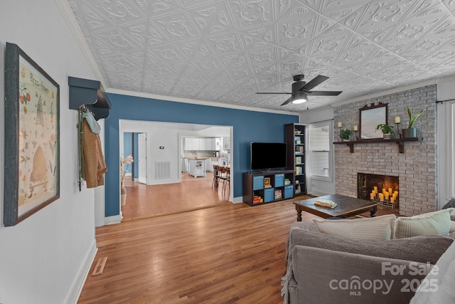 1001 Old Charlotte Rd, Concord, NC 28027 - living room featuring an ornate ceiling, wood finished floors, a brick fireplace, a ceiling fan, and baseboards