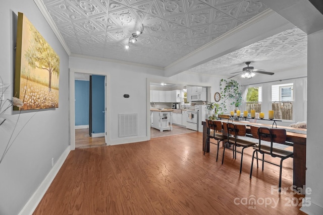 1001 Old Charlotte Rd, Concord, NC 28027 - dining area featuring an ornate ceiling, crown molding, light wood-style flooring, baseboards, and a ceiling fan