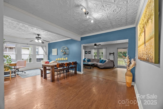 1001 Old Charlotte Rd, Concord, NC 28027 - dining room featuring a ceiling fan, baseboards, an ornate ceiling, wood finished floors, and crown molding
