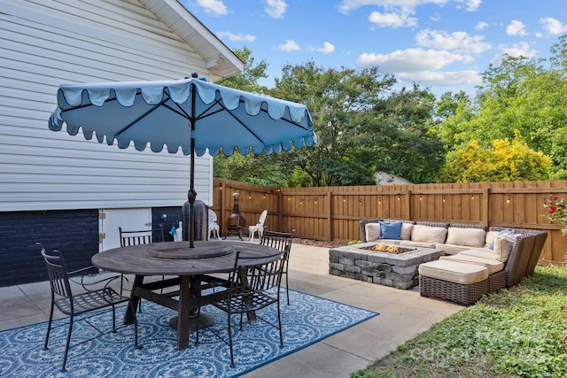 1001 Old Charlotte Rd, Concord, NC 28027 - view of patio featuring a fenced backyard, outdoor dining space, and an outdoor living space with a fire pit