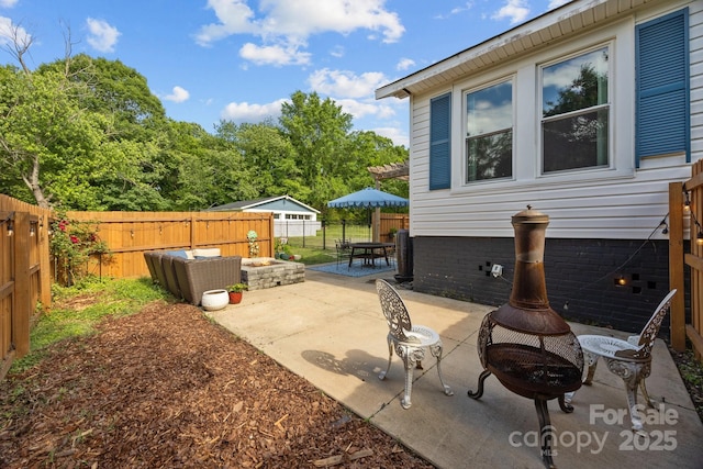 1001 Old Charlotte Rd, Concord, NC 28027 - view of patio / terrace with an outdoor fire pit and a fenced backyard