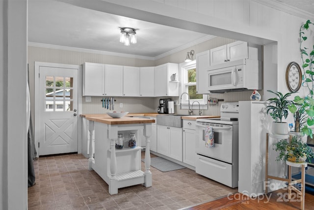 1001 Old Charlotte Rd, Concord, NC 28027 - kitchen featuring white appliances, butcher block countertops, healthy amount of natural light, white cabinets, and ornamental molding