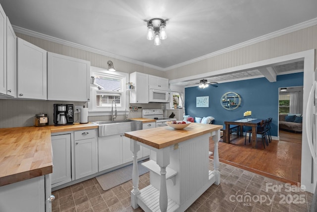 1001 Old Charlotte Rd, Concord, NC 28027 - kitchen with wood counters, white appliances, a sink, crown molding, and white cabinetry