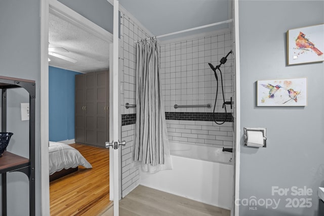 1001 Old Charlotte Rd, Concord, NC 28027 - full bathroom featuring wood finished floors, shower / bath combo with shower curtain, a textured ceiling, and ensuite bathroom