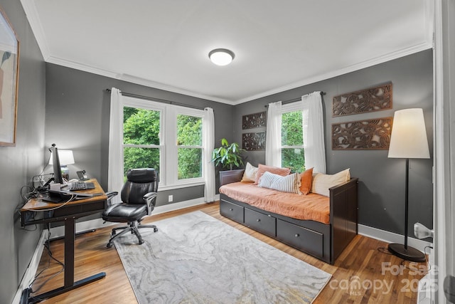 1001 Old Charlotte Rd, Concord, NC 28027 - bedroom with ornamental molding, baseboards, an office area, wood finished floors, and baseboard heating