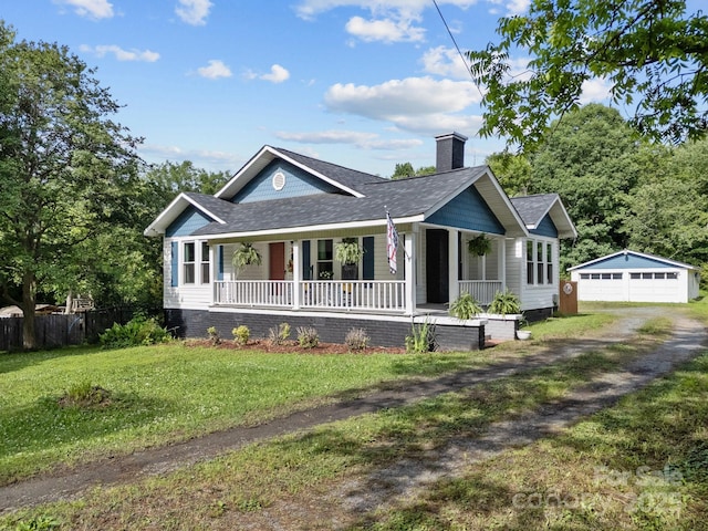 1001 Old Charlotte Rd, Concord, NC 28027 - view of front of house with covered porch, a garage, an outdoor structure, roof with shingles, and a chimney