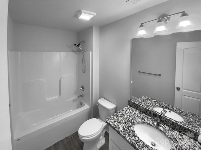 full bathroom featuring vanity, toilet, wood finished floors, and tub / shower combination