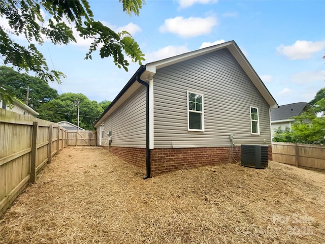 view of home's exterior featuring a fenced backyard and central air condition unit