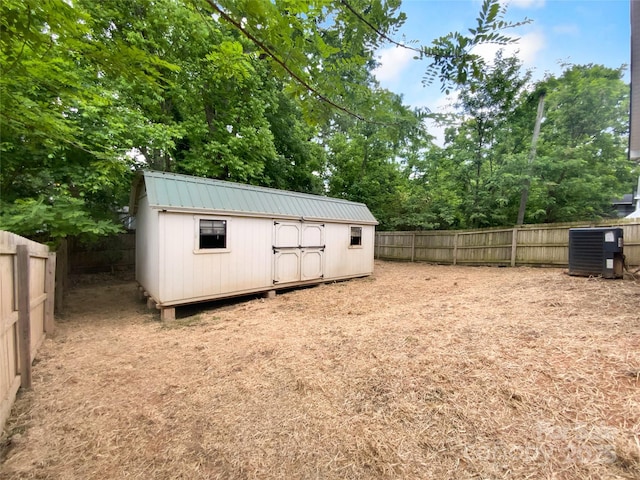 view of shed featuring a fenced backyard and cooling unit