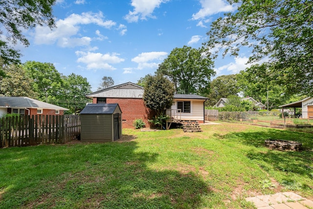 view of yard featuring a fenced backyard, an outbuilding, a shed, and a wooden deck