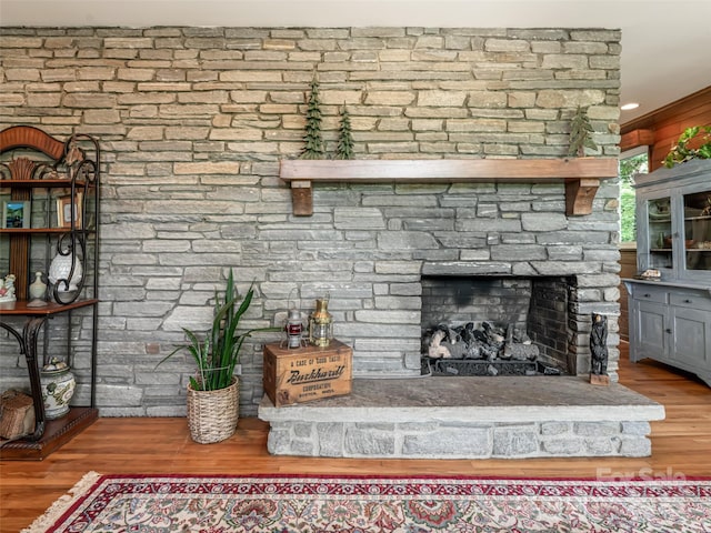 interior details featuring a fireplace and wood finished floors