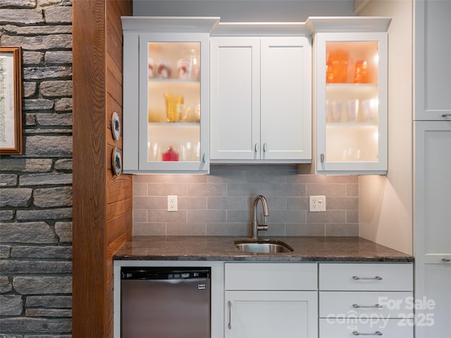 bar with stainless steel dishwasher, backsplash, a sink, and indoor wet bar